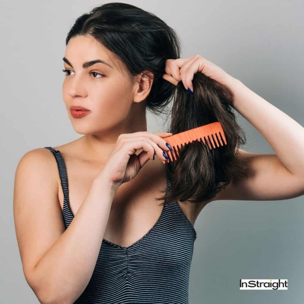 lady combing her wet hair before styling it